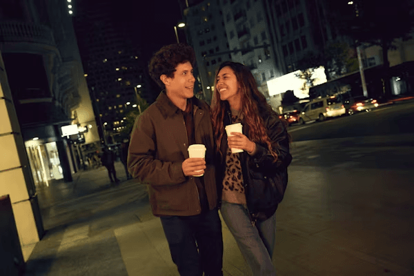 A couple walking together through the city at night